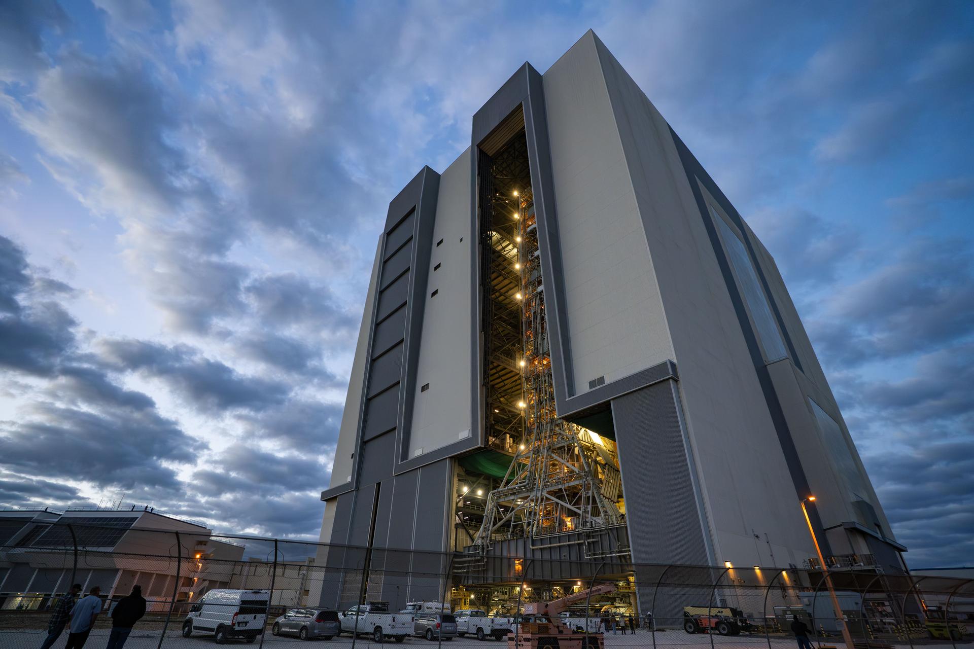 This image shows NASA’s SLS (Space Launch System) and Orion spacecraft rolling out of the Vehicle Assembly Building at NASA’s Kennedy Space Center. NASA's massive Crawler-Transporter, upgraded for the Artemis program, carries the powerful SLS rocket and Orion spacecraft on the Mobile Launcher from the Vehicle Assembly Building to Launch Pad 39B at Kennedy Space Center   in preparation for the Artemis II mission.  